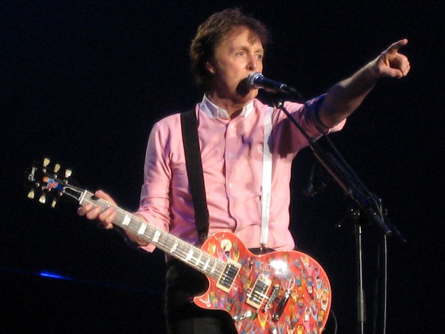 Paul McCartney is a very humble billionaire. Here, he is performing a concert.