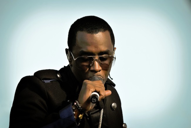 Sean 'Diddy' Combs is seen here posing for a photoshoot, holding a microphone.